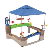 Plastic water activity center with blue shade canopy and pump-and-splash play station