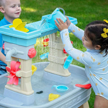 Plastic water table with spinning splash wheel and side water outlets, light blue