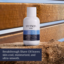 Cooling shave oil bottle with white cap and blue label on tabletop