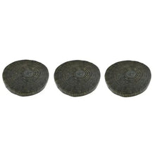 Three round dark stepping stones with concentric circle designs on top