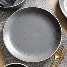 Gray speckled stoneware dinner plate with ridged rim and speckled surface