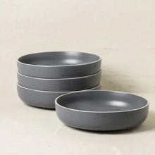 Gray speckled stoneware dinnerware set, stacked bowls and shallow plates
