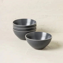 Gray speckled stoneware dinnerware set with two bowls and stacked plates