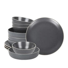 Gray speckled stoneware dinnerware set with multiple stacked serving pieces