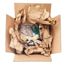 Gift set contents in kraft box with crinkled paper and wrapped items