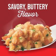 Savory, buttery flavored chicken stuffing in a serving spoon with herbs