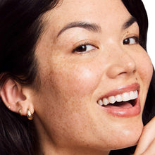 Smiling woman with smooth skin on cheek and jawline
