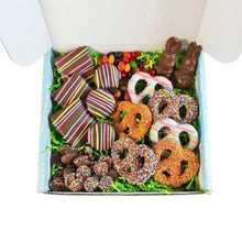 Easter chocolate assortment in an open box with bunnies, rings, and sprinkle cookies