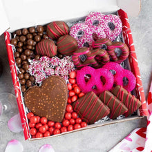 Valentine chocolate gift box with heart chocolate, striped truffles, pink sponge-like treats