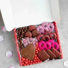 Valentine chocolate gift box with heart chocolate, striped chocolates, pink frosted treats