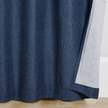 Blue blackout curtain panel edge with soft fold and linen-textured fabric
