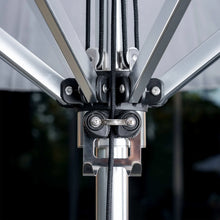 Umbrella opening mechanism with black hardware and tied cords near pole