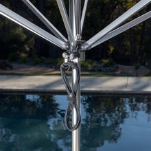 Patio umbrella pole with hanging cords and metal hardware attachment