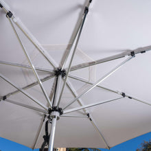 Underside of open patio umbrella with metal cross braces and fabric panels