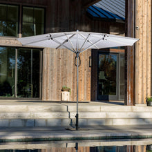 Patio umbrella with white flat canopy and central pole, fully opened