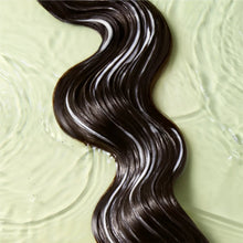 Long wavy dark brown hair in smooth, soapy water, shiny curls
