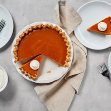 Baked pie in a white serving dish with scalloped crust edge