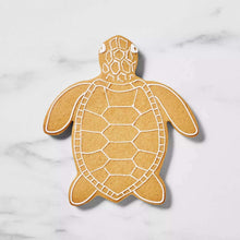 Sea turtle cookie in tan with white shell and outline details.