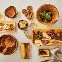 Acacia oval wooden serving platter with cutout handle, visible wood grain.