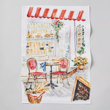 White bakery-themed kitchen towel with illustrated window, chairs, and wreath