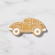 Car-shaped sugar cookie with white icing lines and small wheel details