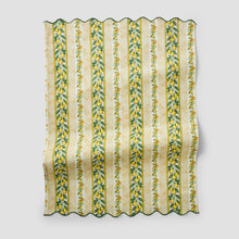 Citrus kitchen towel with yellow-green vertical stripes and fruit leaf print