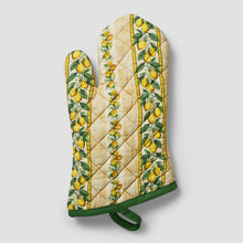 Quilted oven mitt in cream with lemon floral print, green cuff and hanging loop.
