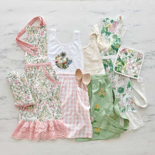 Floral embroidered apron assortment with pink, green, and white patterns