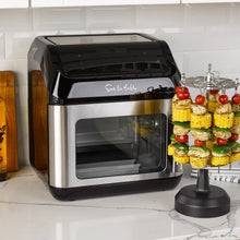 Multi-function air fryer with kebab skewer rack and mesh window, stainless body.