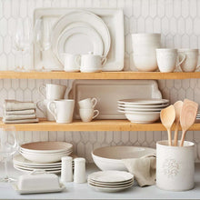 Square pearl stoneware appetizer plate, stacked with matching pieces on shelf