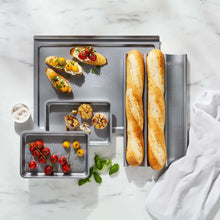 Cookie sheet set with removable tray insert and side rack, holding baguette-style breads