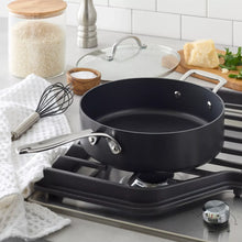 Nonstick sauté pan on stovetop with long handle and side grips