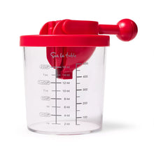 Tomato and grape slicer with red lid and handle, clear measuring cup with volume markings