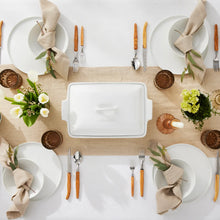Set of white coupe cereal bowls arranged on a table setting