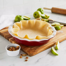 Red ceramic pie dish with fluted rim, holding uncooked pie crust, 9.5-inch