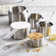 Stainless steel measuring cups with metal handles and engraved measurement markings