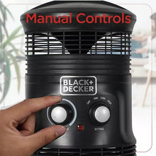 Black space heater with hand adjusting the front control knobs