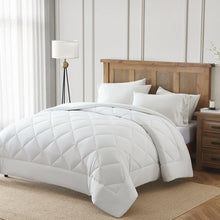 White cooling comforter with diamond stitching, shown on a made bed