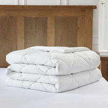 White cooling comforter set, folded and stacked with quilted baffles