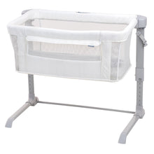 Cream co-sleeping bassinet with breathable mesh sides and folding stand legs