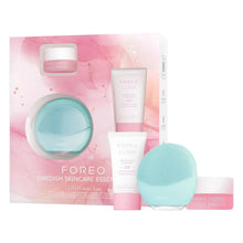 Foreo LUNA mini 3 set with turquoise facial cleansing brush and pink skincare tubes