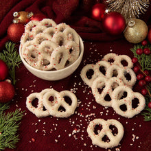 White peppermint pretzels on a tray with cream glaze and red sugar sprinkles