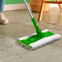 Swiffer dry sweeping cloth refill on a floor sweeper head for dry dust pickup