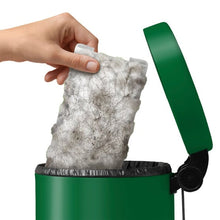 Hand holding a dusty gray Swiffer dry sweeping cloth refill for heavy duty cleaning