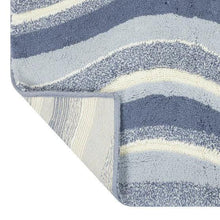 Swirl bath rug corner detail with textured navy, light gray, and cream stripes