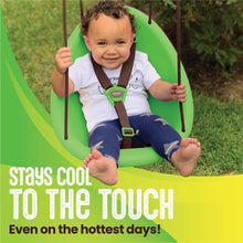 Green baby swing outdoors with toddler seated, harness fastened, legs forward