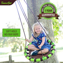 Child using green-and-black striped tree swing saucer with brown padded seat