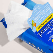 Witch hazel cleansing cloths, white wipe pulled from blue pouch