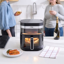 T-fal air fryer on countertop with glass window showing cooking food