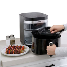 T-fal air fryer with open drawer basket being pulled out